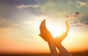 The Power of Gratitude - hands holding the sun with sunset on backgound ** Note: Visible grain at 100%, best at smaller sizes