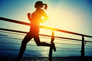 Maintaining Healthy Habits - healthy lifestyle sports woman running on wooden boardwalk sunrise seaside
