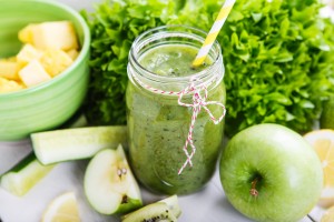 Fresh organic green smoothie with salad apple cucumber pineapple and lemon as healthy drink